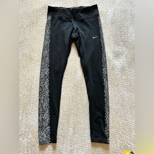 Nike running women’s size medium leggings. Black with light-reflecting design.